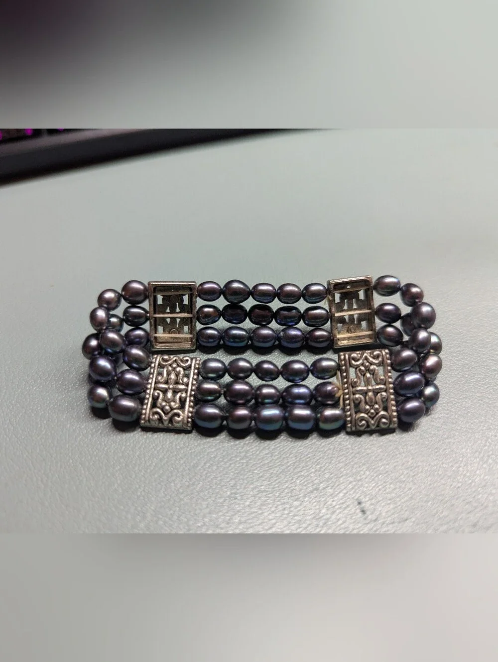 Multi-Strand Black Pearl Bracelet with Ornate Silver Accents